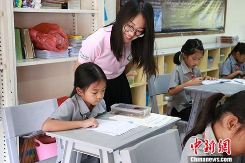 資料圖：隨著“一帶一路”建設(shè)的推進(jìn)，泰國(guó)“漢語(yǔ)熱”持續(xù)升溫。圖為孔敬大學(xué)附小考場(chǎng)內(nèi)監(jiān)考老師在細(xì)心指導(dǎo)小學(xué)生。 <a target='_blank' >中新社</a>記者 李萍萍 攝