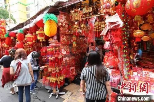 圖為顧客在選購(gòu)春節(jié)喜慶裝飾品?！×钟纻?攝
