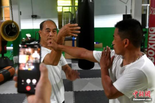 　福建省武術協(xié)會鳴鶴拳研究會會長余丹秋與徒弟們通過微信群視頻為澳大利亞鳴鶴拳愛好者傳授鳴鶴拳入門套路“八步連”。呂明 攝