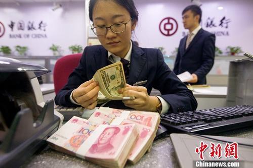 中國僑網(wǎng)資料圖:銀行工作人員正在清點貨幣。中新社記者 張云 攝